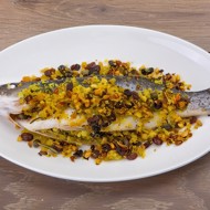 Сибас, запеченный с кедровыми орешками и изюмом