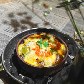 Жюльен из раковых шеек с луком-пореем в печеном картофеле