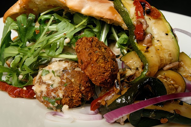 Пита с пряными мясными шариками, рукколой, майонезом с хариссой и дольками картофеля